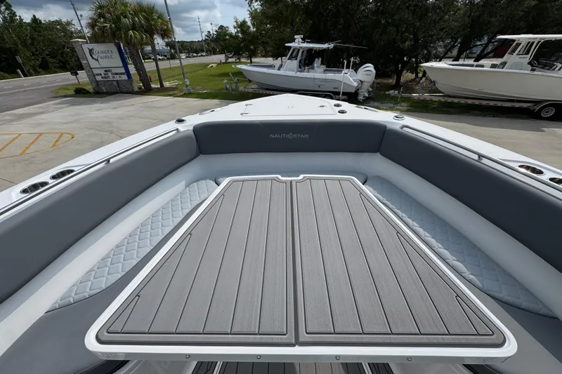 Slide: The Image of 2026 NauticStar 332 Offshore boat deck with cushioned seating and sleek design. - 19