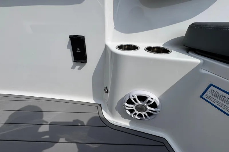 Slide: The Image of 2026 NauticStar 332 Offshore boat interior with cup holders and speaker. - 24