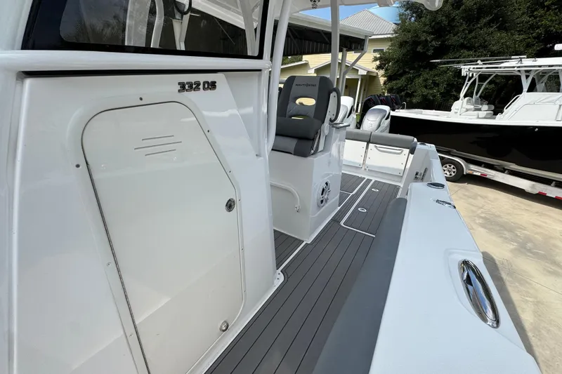 Slide: The Image of 2026 NauticStar 332 Offshore boat interior with seating and storage compartments. - 26