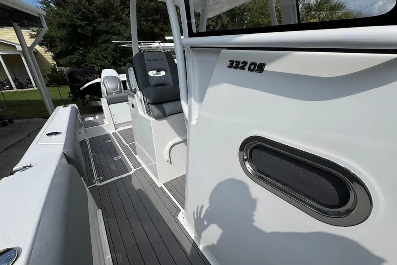 Slide: The Image of 2026 NauticStar 332 Offshore boat interior with seating and sleek design. - 27