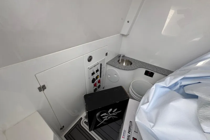 Slide: The Image of Interior of 2026 NauticStar 332 Offshore boat with control panel and sink. - 28