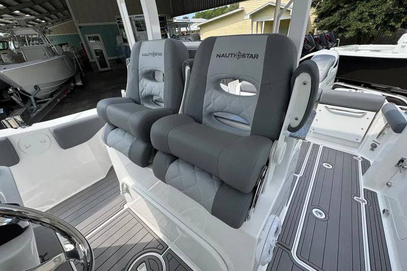 Slide: The Image of 2026 NauticStar 332 Offshore boat with luxurious gray seating and modern design. - 29