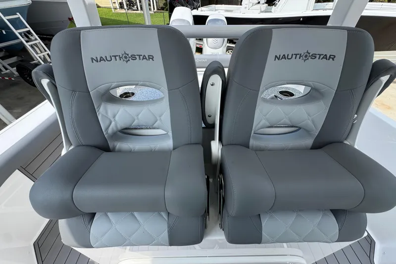 Slide: The Image of Luxury seating on 2026 NauticStar 332 Offshore boat, featuring gray cushioned seats. - 30