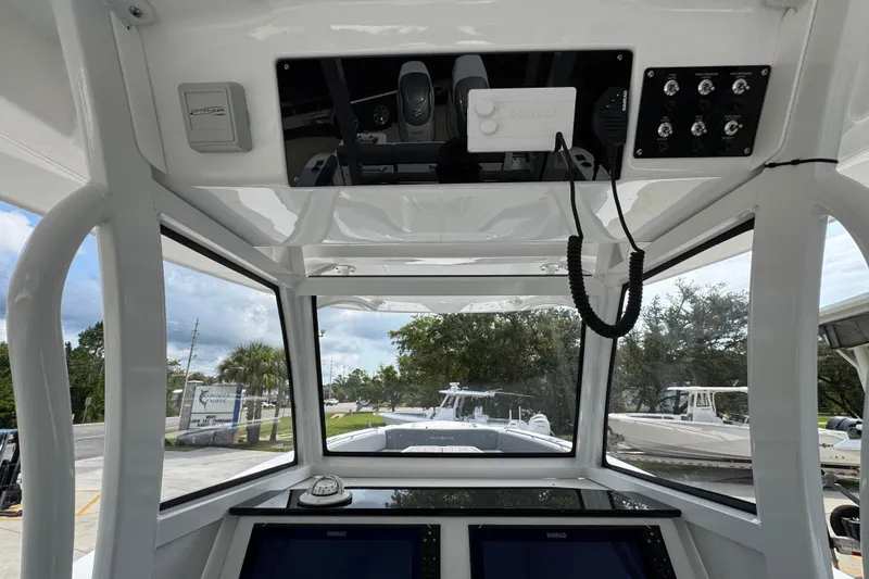 Slide: The Image of Interior view of 2026 NauticStar 332 Offshore boat cockpit with navigation equipment. - 34