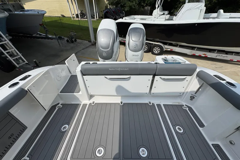 Slide: The Image of 2026 NauticStar 332 Offshore boat deck with dual Suzuki 350 engines. - 42