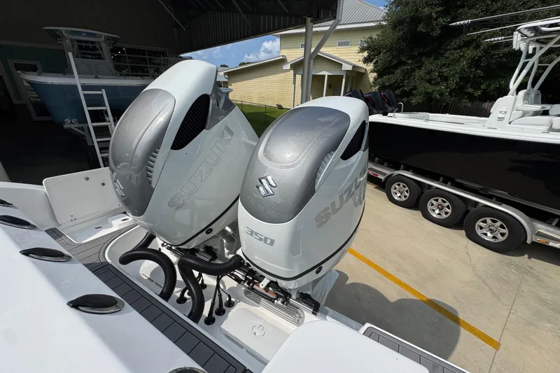 Slide: The Image of Twin Suzuki 350 outboard engines on a 2026 NauticStar 332 Offshore boat. - 44