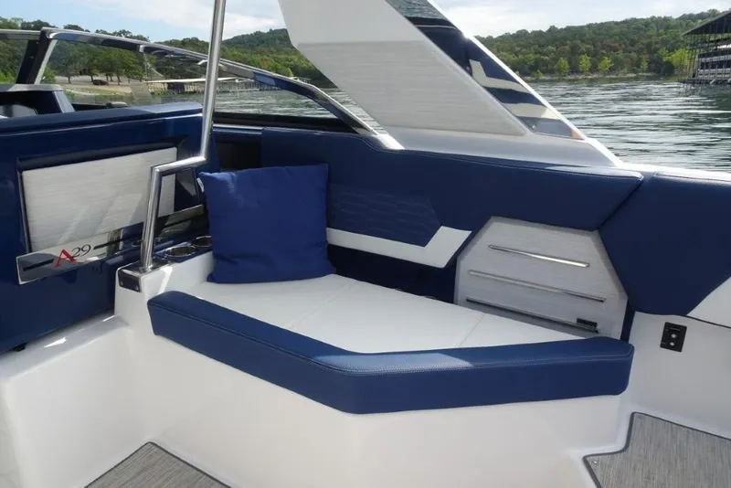 Slide: The Image of 2023 Cobalt A29 boat interior with blue and white seating, lake view in background. - 13