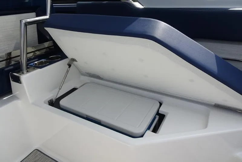 Slide: The Image of 2023 Cobalt A29 boat storage compartment with open lid and built-in cooler. - 14