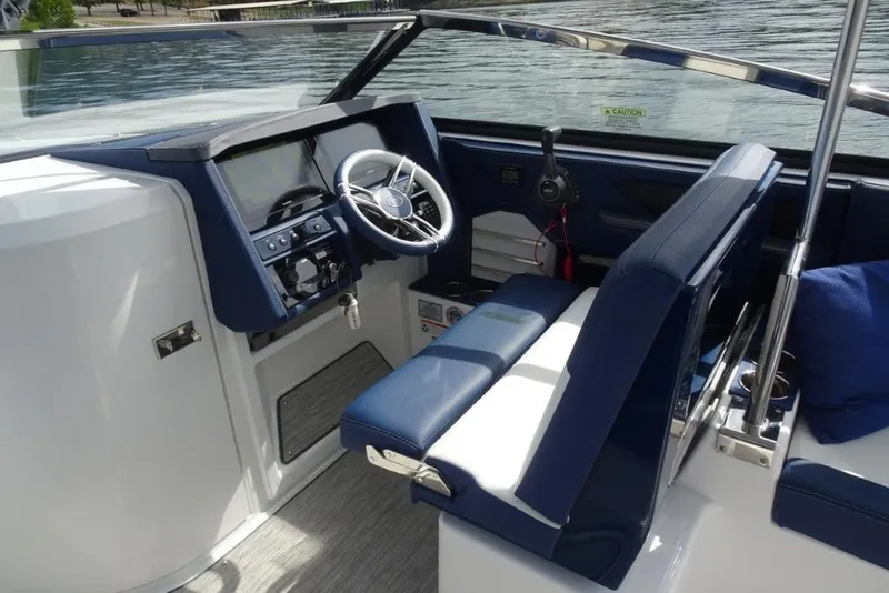 Slide: The Image of 2023 Cobalt A29 boat interior with modern dashboard and blue seating. - 16
