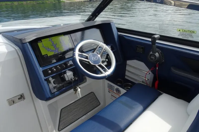 Slide: The Image of 2023 Cobalt A29 boat cockpit with steering wheel and navigation display. - 17