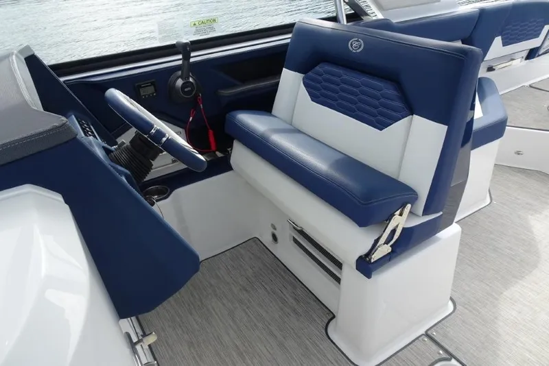 Slide: The Image of 2023 Cobalt A29 boat interior with blue and white seating and steering wheel. - 21