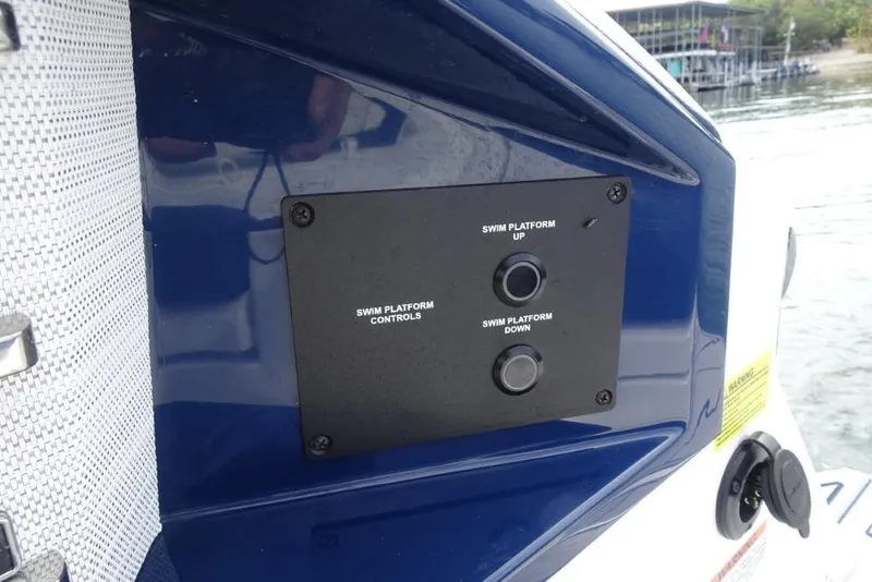 Slide: The Image of 2023 Cobalt A29 swim platform controls on boat exterior. - 31