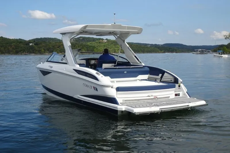 Slide: The Image of 2023 Cobalt A29 boat cruising on a serene lake with scenic hills in the background. - 4