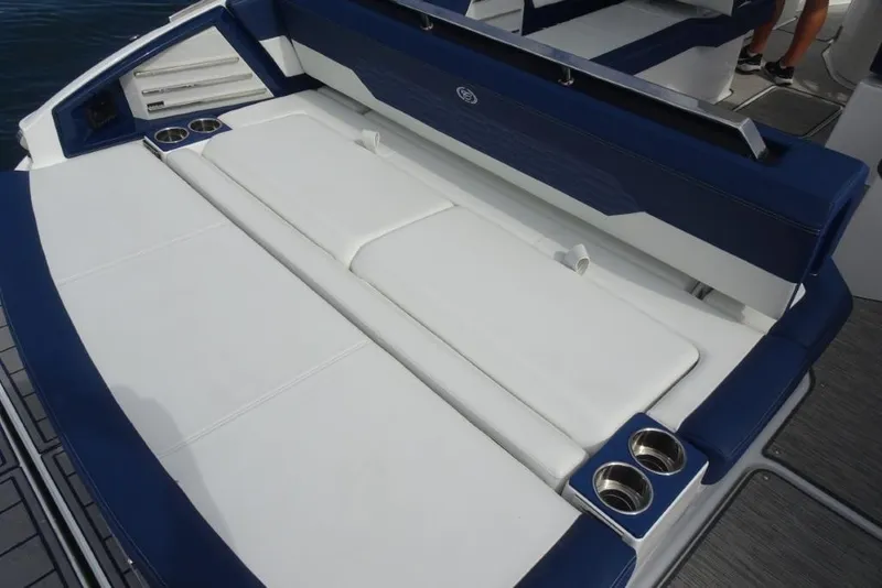 Slide: The Image of 2023 Cobalt A29 boat with luxurious white and blue seating and built-in cup holders. - 9