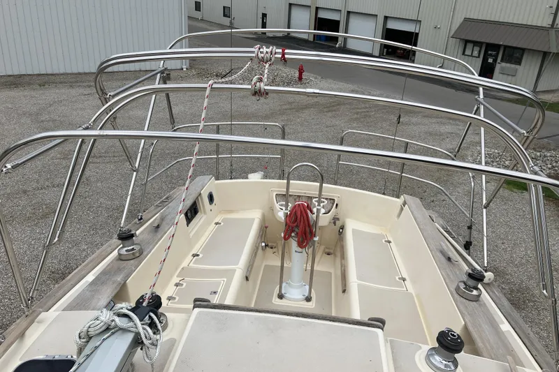 Slide: The Image of 1990 Island Packet 32 Cutter sailboat cockpit with stainless steel railings and ropes. - 10