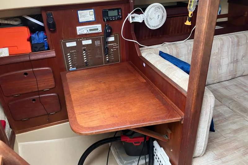 Slide: The Image of Interior of 1990 Island Packet 32 Cutter with navigation station and wooden table. - 36