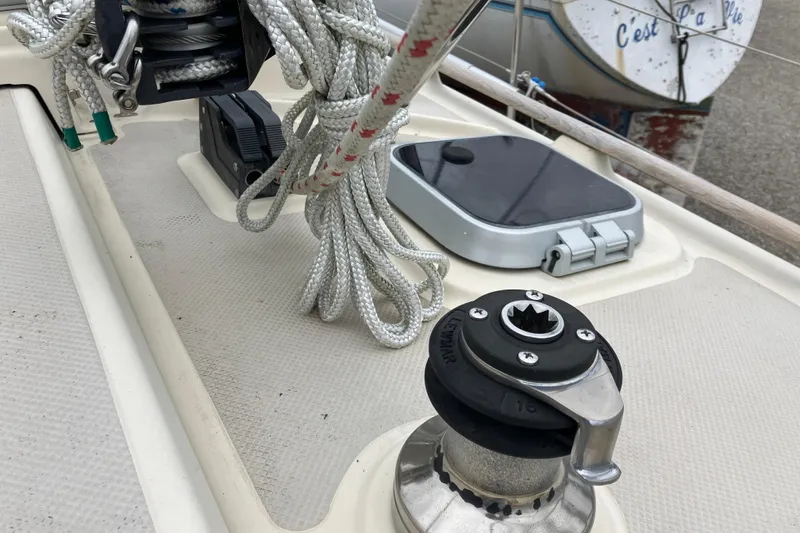 Slide: The Image of Deck of 1990 Island Packet 32 Cutter with winch, ropes, and hatch. - 45