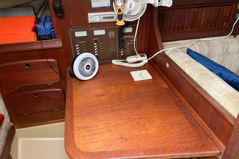 Slide: The Image of 1990 Island Packet 32 Cutter interior with navigation station and control panel. - 38