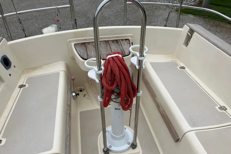 Slide: The Image of Cockpit of 1990 Island Packet 32 Cutter with red rope and seating area. - 43