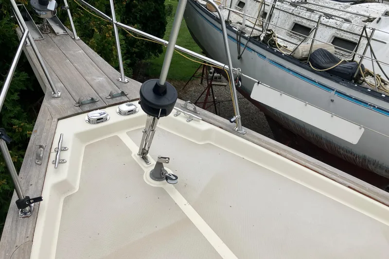 Slide: The Image of 1990 Island Packet 32 Cutter deck with railing and adjacent boat in view. - 14