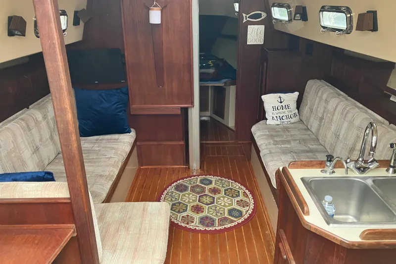 Slide: The Image of Interior of 1990 Island Packet 32 Cutter sailboat with cozy seating and kitchenette. - 19