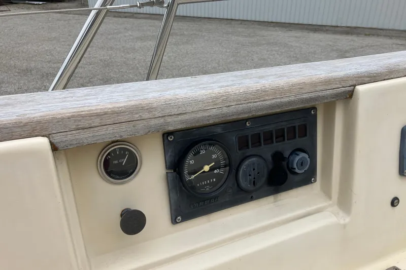 Slide: The Image of Control panel of a 1990 Island Packet 32 Cutter sailboat, featuring gauges and switches. - 42