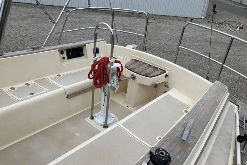 Slide: The Image of Cockpit of 1990 Island Packet 32 Cutter sailboat with steering wheel and red rope. - 5