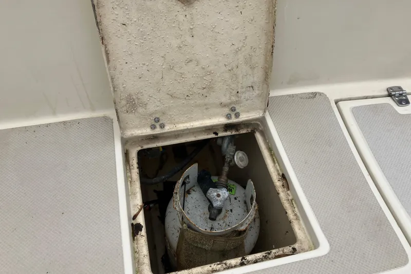 Slide: The Image of Open hatch on 1990 Island Packet 32 Cutter revealing storage compartment. - 41