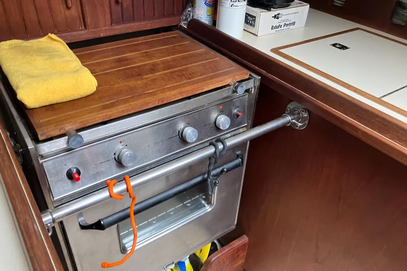 Slide: The Image of Galley kitchen in 1990 Island Packet 32 Cutter sailboat with stove and wooden countertop. - 32