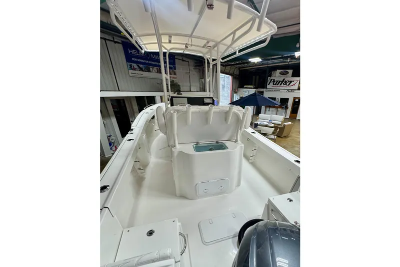 Slide: The Image of 2026 Parker 21SE Center Console boat interior with seating and storage in showroom. - 4
