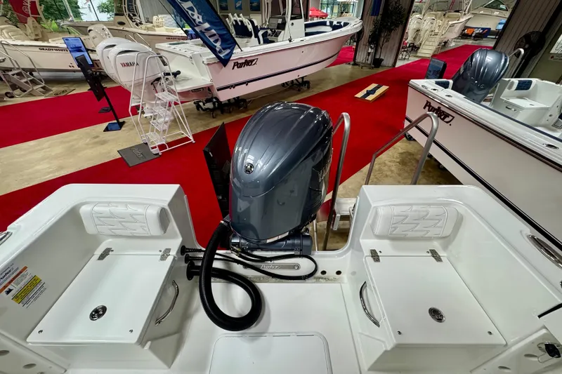 Slide: The Image of 2026 Parker 21SE Center Console boat with Yamaha outboard motor in showroom display. - 6
