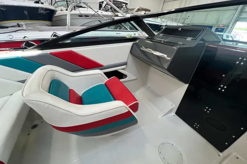 Slide: The Image of Cockpit of a 1990 Powerplay Spectra XL boat with steering wheel and control panel. - 11