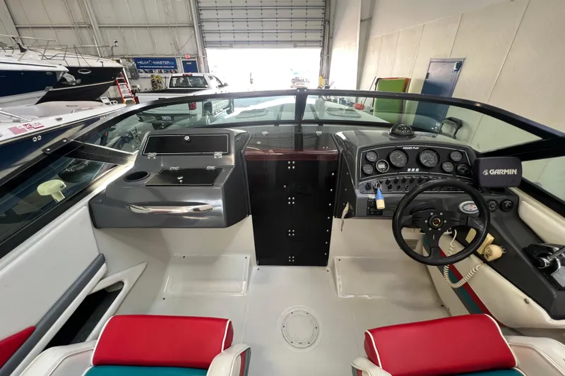 Slide: The Image of Interior of a 1990 Powerplay Spectra XL boat with colorful seating and sleek dashboard. - 12