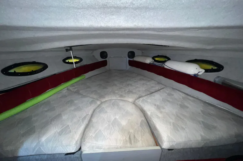 Slide: The Image of Interior cabin of 1990 Powerplay Spectra XL boat with cushioned seating and portholes. - 17