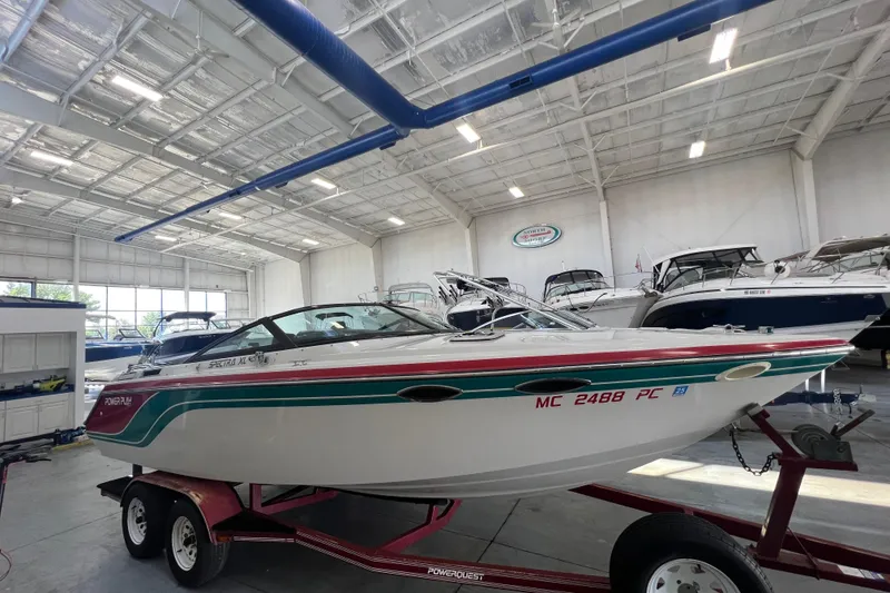 Slide: The Image of 1990 Powerplay Spectra XL boat in a spacious indoor storage facility. - 2