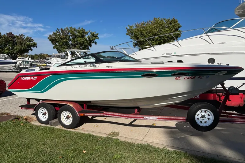 Slide: The Image of 1990 Powerplay Powerboats Spectra XL on trailer, vibrant design, parked outdoors. - 20