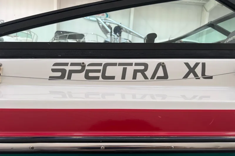Slide: The Image of 1990 Powerplay Spectra XL boat on trailer in indoor showroom. - 3