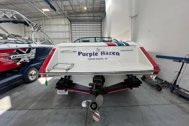 Slide: The Image of 1990 Powerplay Spectra XL boat with red and white detailing in a showroom. - 4