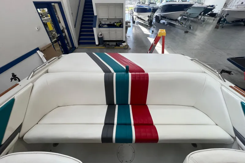 Slide: The Image of 1990 Powerplay Spectra XL boat interior with colorful striped seats and dashboard. - 8