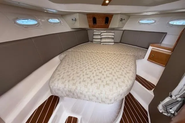 Slide: The Image of 2024 Cutwater C-30 Sedan interior cabin with cozy bed and elegant design. - 16