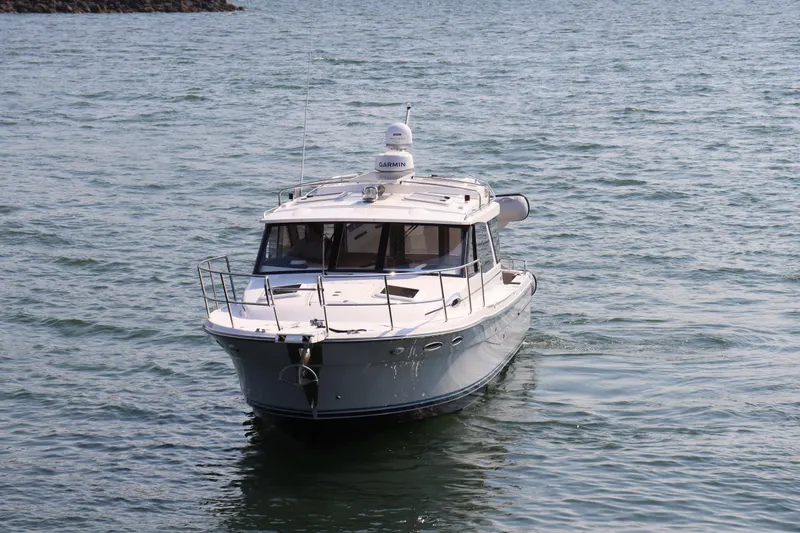 Slide: The Image of 2024 Cutwater C-30 Sedan cruising on open water. - 2