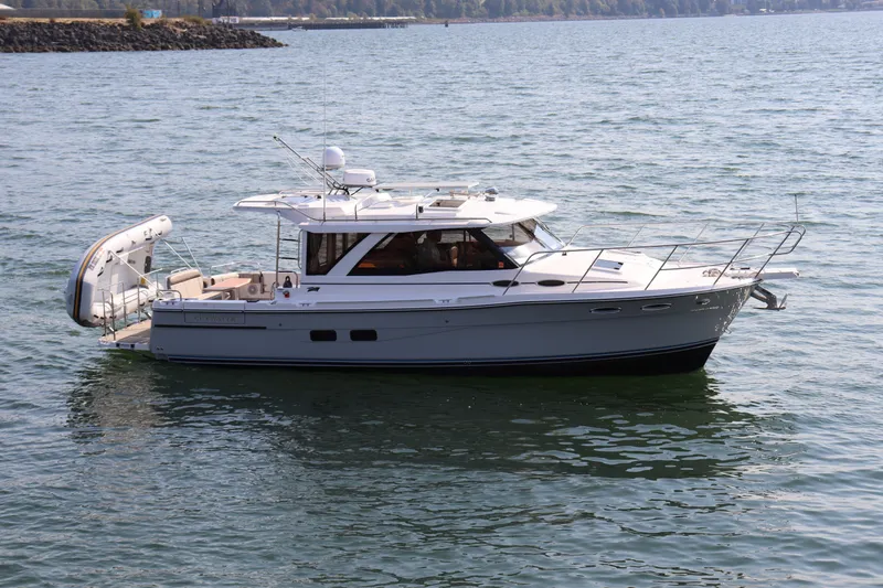 Slide: The Image of 2024 Cutwater C-30 Sedan boat on calm water, side view. - 5