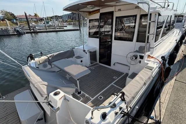 Slide: The Image of 2024 Cutwater C-30 Sedan boat docked at marina, featuring spacious deck and modern design. - 7