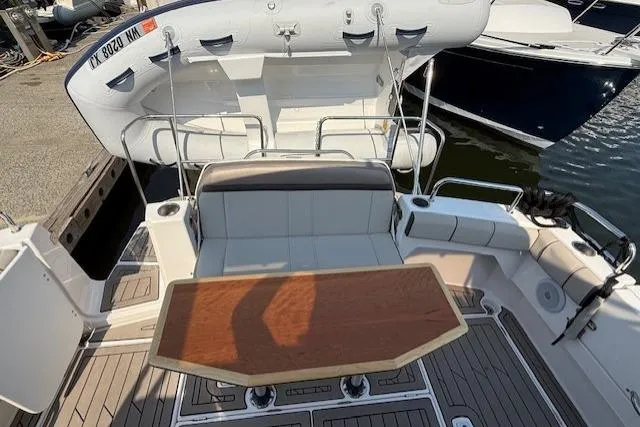 Slide: The Image of 2024 Cutwater C-30 Sedan boat interior with seating and wooden table. - 8