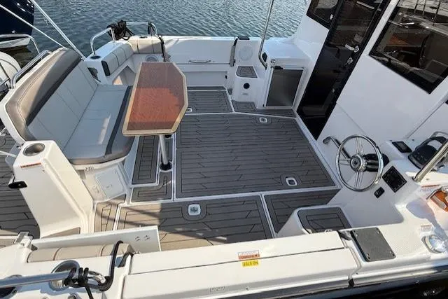 Slide: The Image of 2024 Cutwater C-30 Sedan boat interior with seating, table, and steering wheel. - 9