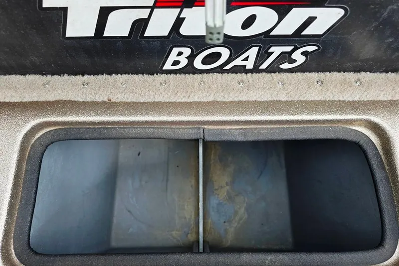 Slide: The Image of Triton SF18 F&S 2005 boat compartment with logo, showcasing storage space. - 10