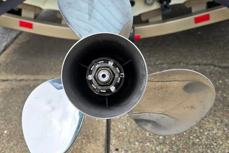 Slide: The Image of Close-up of a 2005 Triton SF18 F&S boat propeller on a concrete surface. - 16