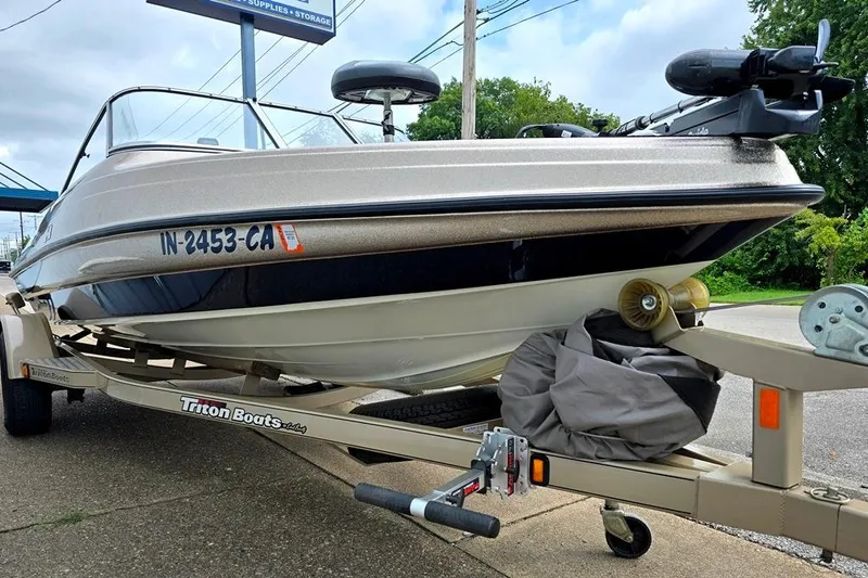 Slide: The Image of 2005 Triton SF18 F&S boat on trailer, parked outdoors. - 17