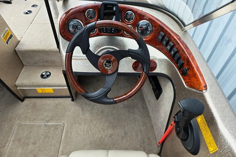 Slide: The Image of 2005 Triton SF18 F&S boat dashboard with wood accents and steering wheel. - 18