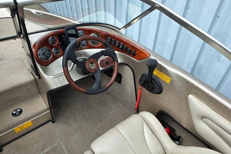 Slide: The Image of 2005 Triton SF18 F&S boat cockpit with steering wheel and control panel. - 6
